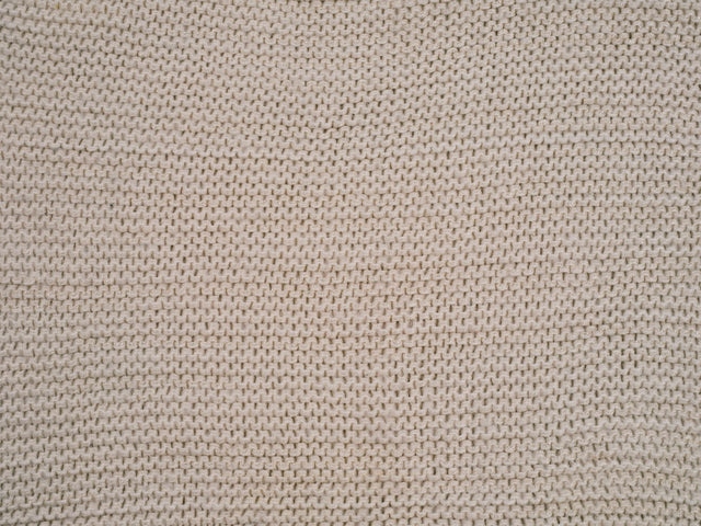 Close-up of a dense knit cotton fabric in natural beige