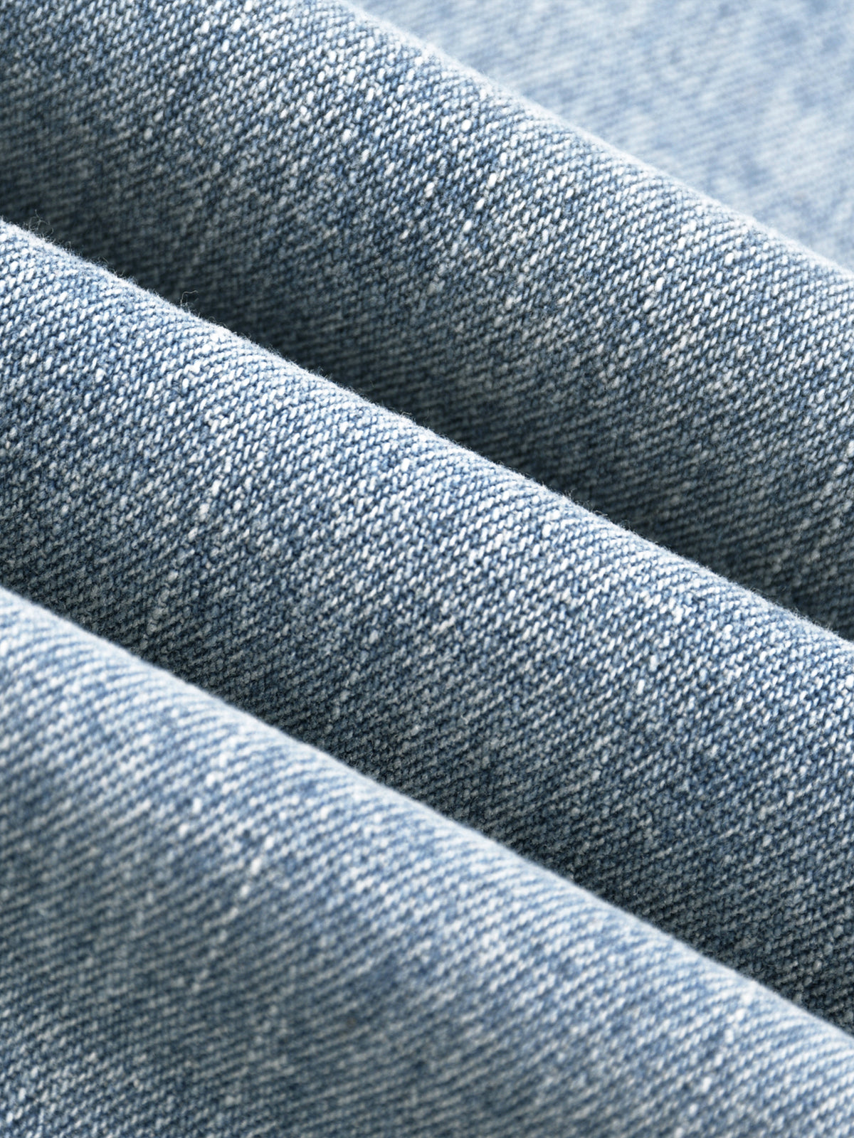 Blue vintage-wash denim jeans, up close